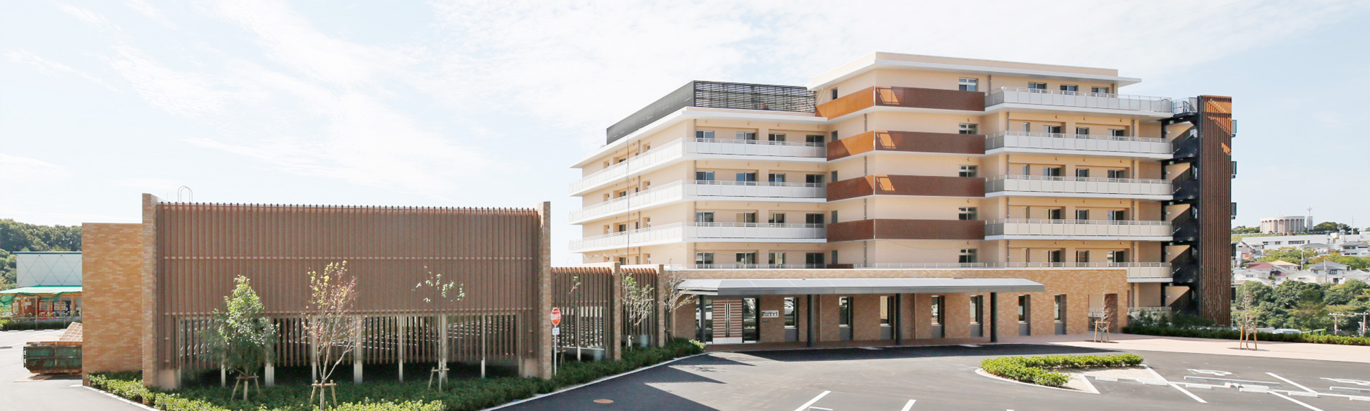 介護施設の建物外観。複数階建ての施設で駐車場を備えた建物